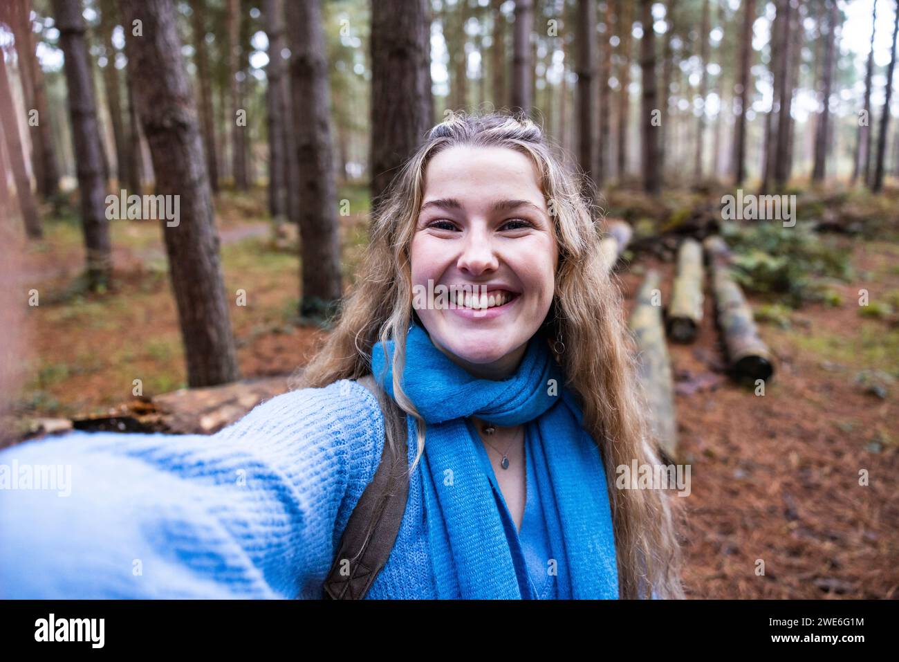 Happy beautiful woman taking selfie in Cannock chase forest Stock Photo
