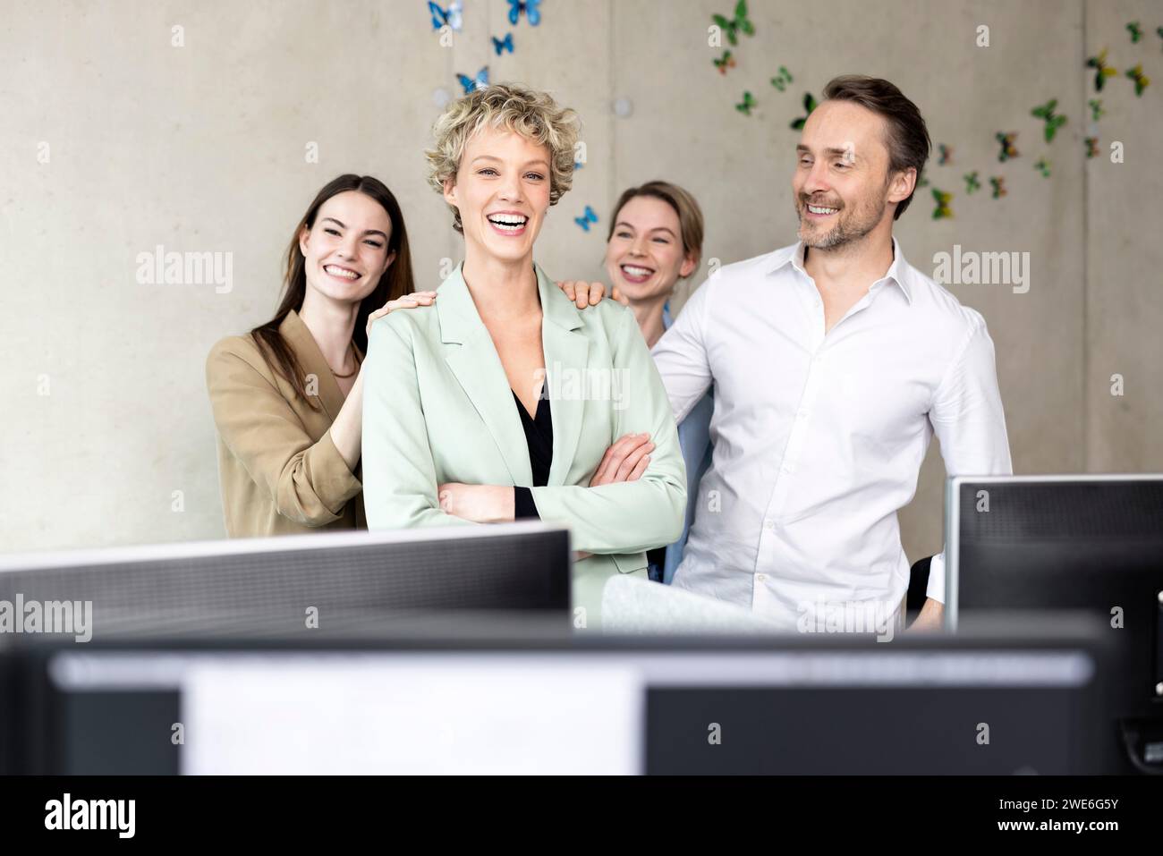 Cheerful business colleagues standing in office Stock Photo