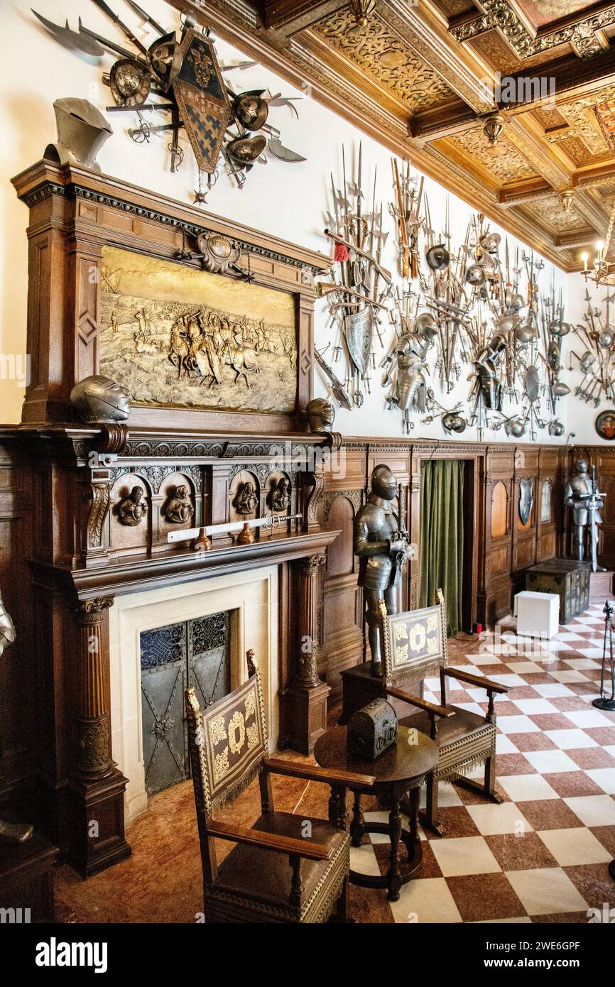 Early 20th century German neo-renaissance interior of the Armoury Halls with fireplace, armour and weapons display, Peles Castle, Sinaia, Romania Stock Photo