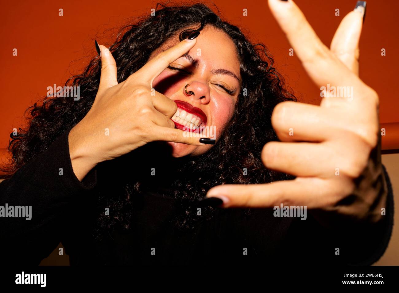 Young woman with cool attitude making Shaka sign Stock Photo