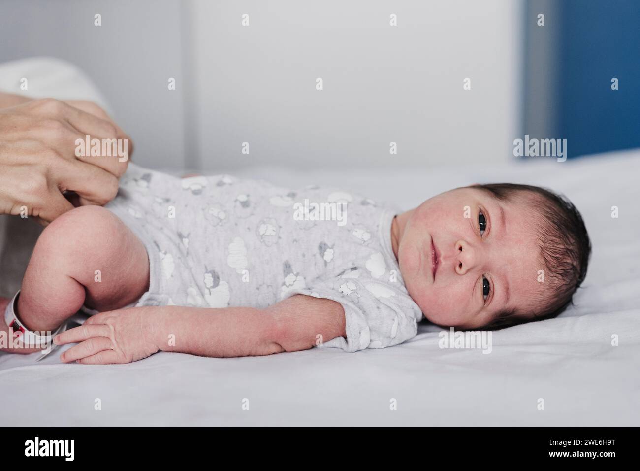 Cute baby girl lying on bed in hospital Stock Photo