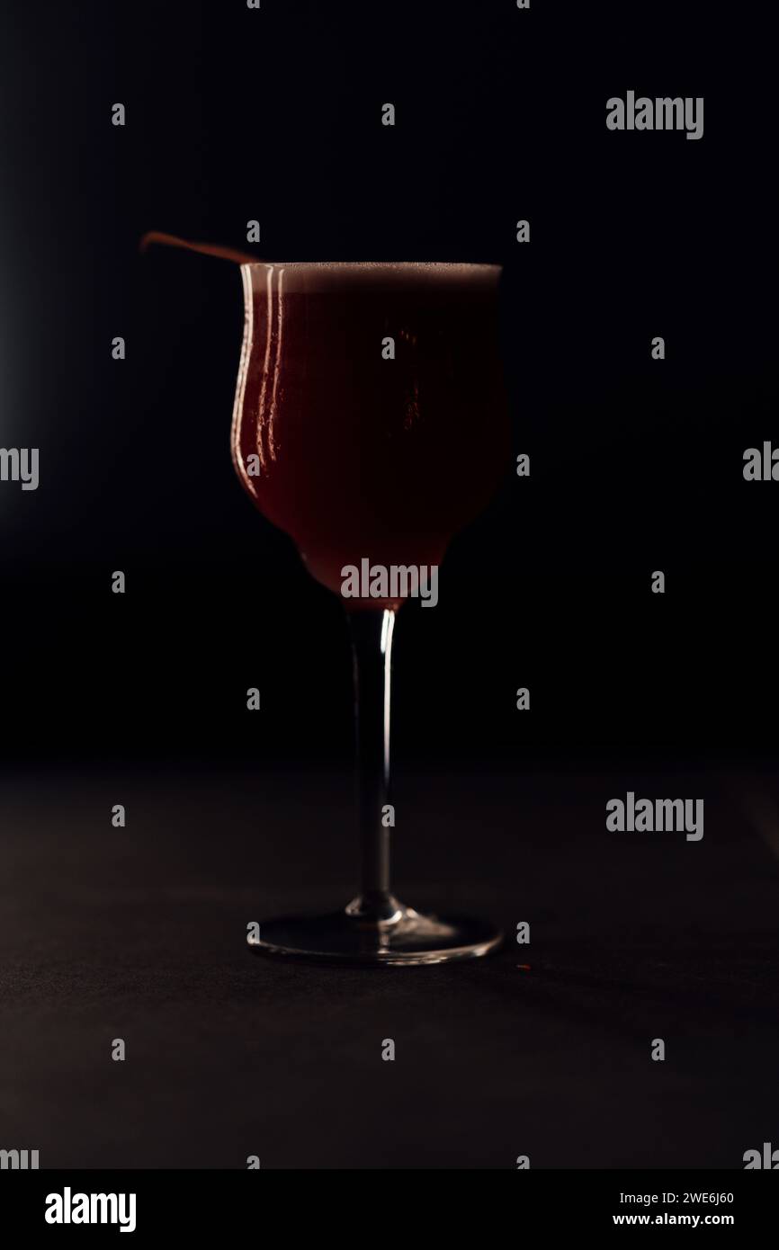 Freshly prepared cocktail drink against black background Stock Photo