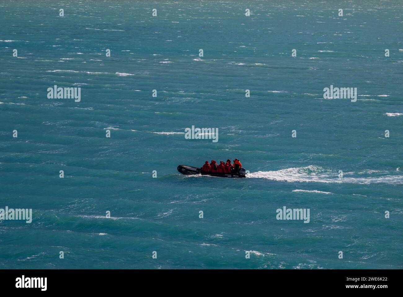 Fortuna Bay, SGI, landscape, mountains, snow, covered peaks,sunny day zodiac with people navigating harbor Stock Photo