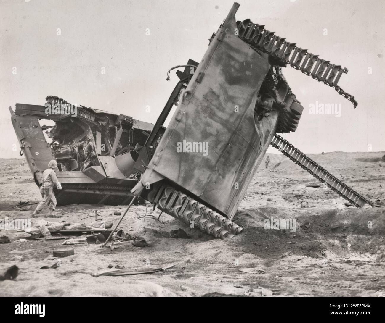Amphibious assault vehicle knocked out by Japanese Land mines and artillery - A Marine casualty lies in a stretcher in the left of the picture - Iwo Jima 1945 Stock Photo