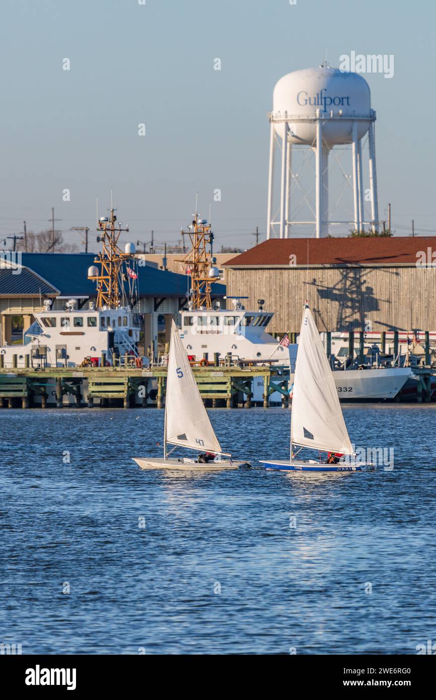 Two male youth sailing on Laser sailboats in the Gulf of Mexico at