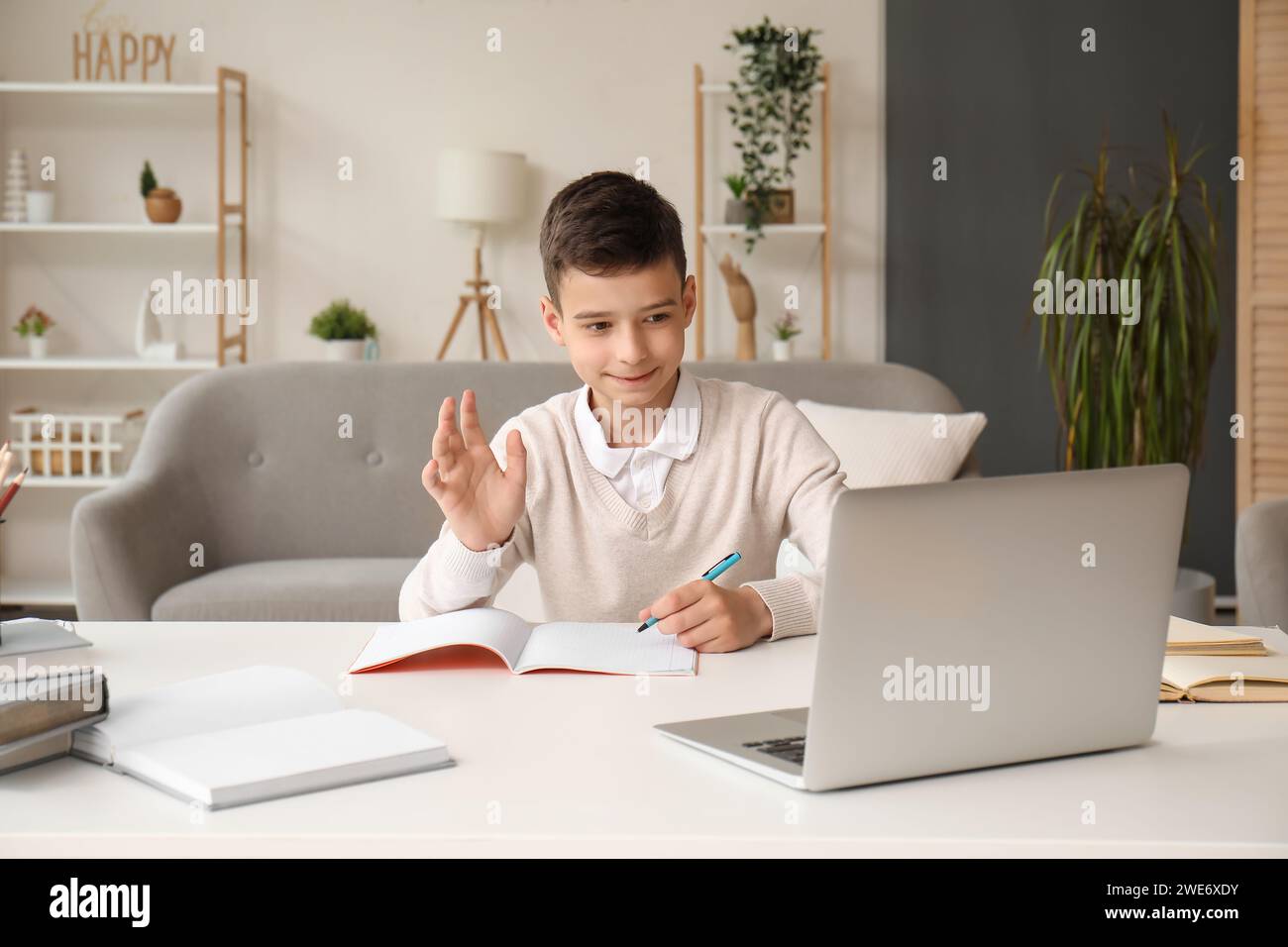 Little boy studying online with laptop at home Stock Photo - Alamy