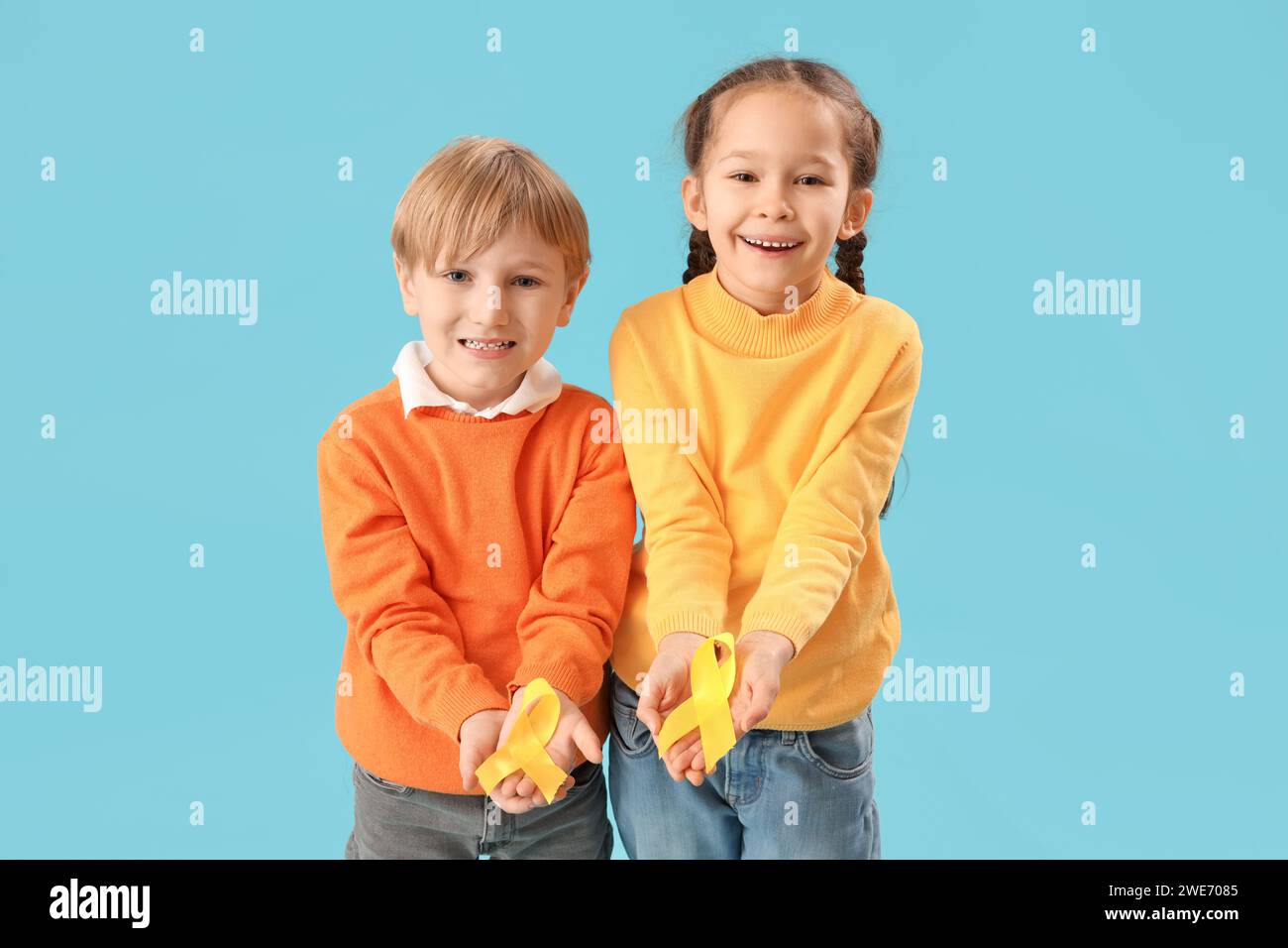 Cute little children with yellow ribbons on blue background. Childhood ...