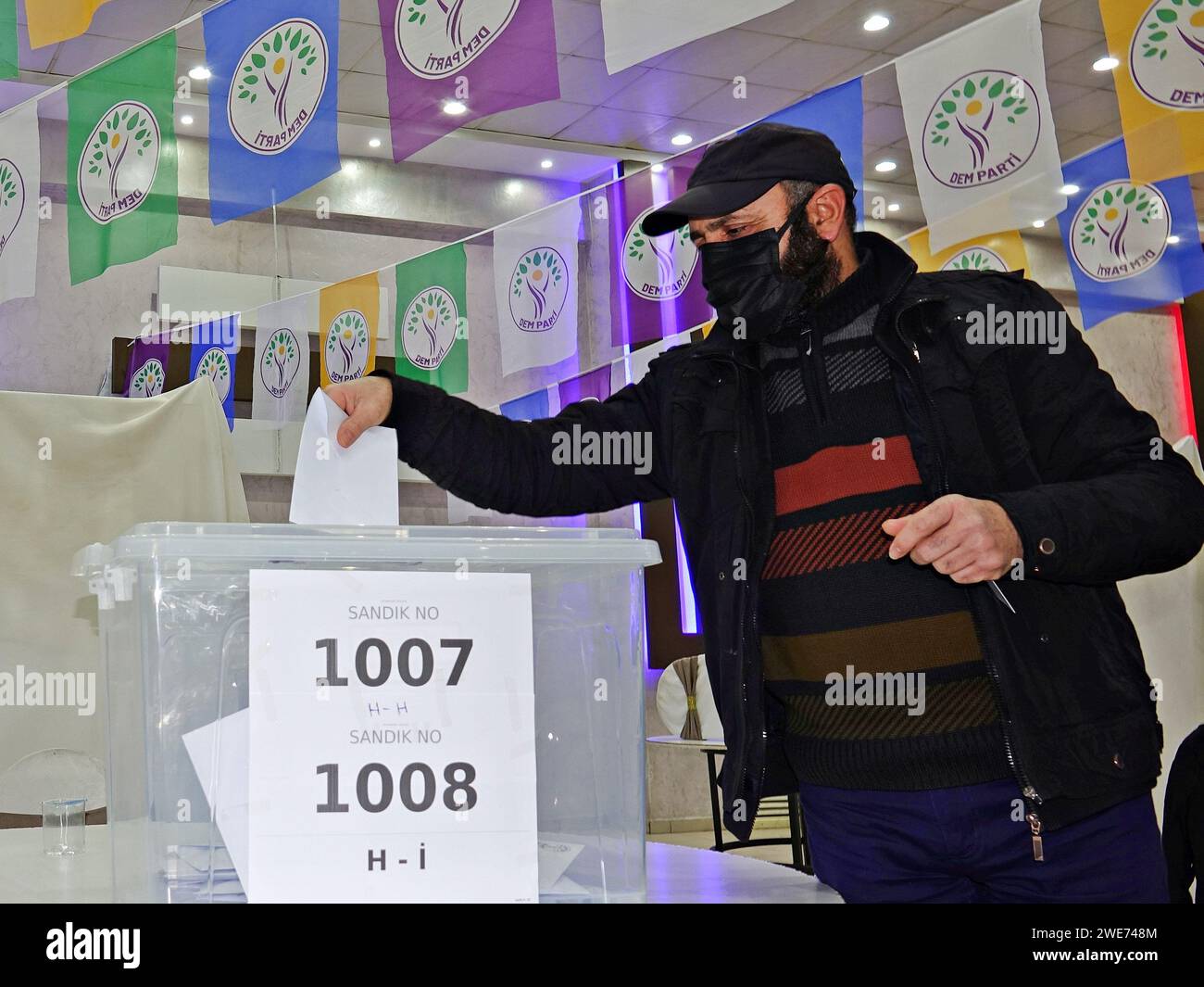 A party member casts his vote at the referendum centre in Yenisehir district of Diyarbakir. The Peoples' Equality and Democracy Party (DEM Party), which is supported by a large part of the Kurdish people living in Turkey, is preparing for the municipal elections to be held across Turkey on 31 March 2024. DEM Party went to a direct referendum in 10 provincial centres and many districts where Kurds live in large numbers, in order to determine the names to be nominated for co-mayors, municipal council members and provincial general assembly members. In Diyarbakir alone, 20 thousand party delegate Stock Photo