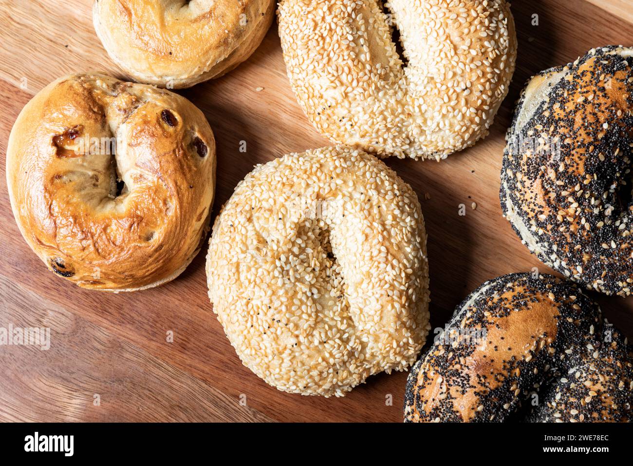 Detailed close-up of freshly baked bagels, generously topped with whole grain seeds. Stock Photo