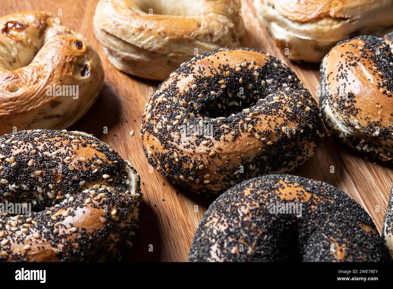 Group of bagels arranged on a wooden surface. Stock Photo