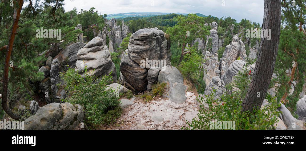 A panoramic view over bizarre rock structures surrounded by forest under a partly cloudy sky, Prachovske skaly, Prachov Rocks, Bohemian Paradise Stock Photo