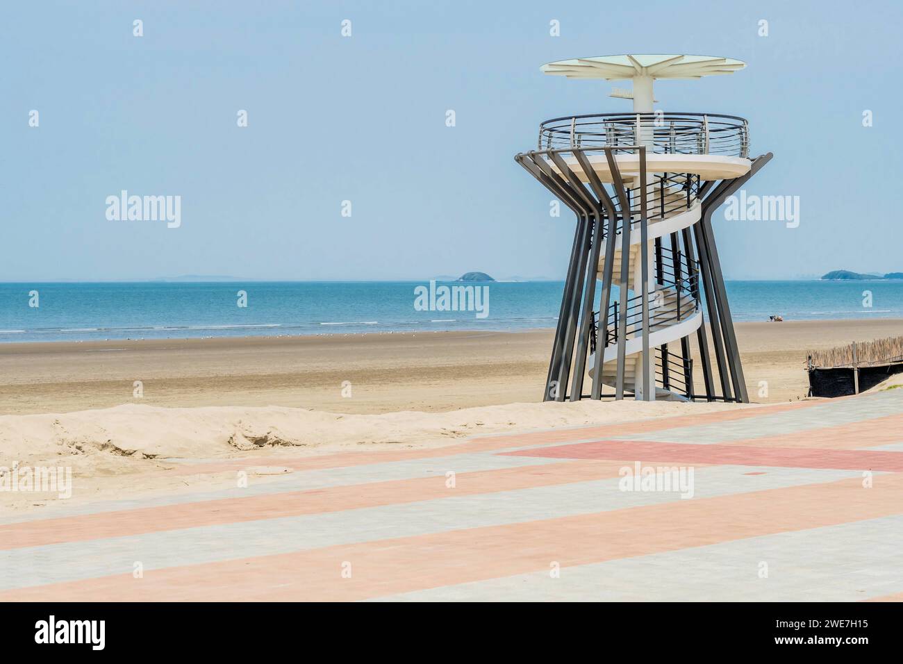 Lookout tower with spiral ramp on beach with ocean in background in South Korea Stock Photo