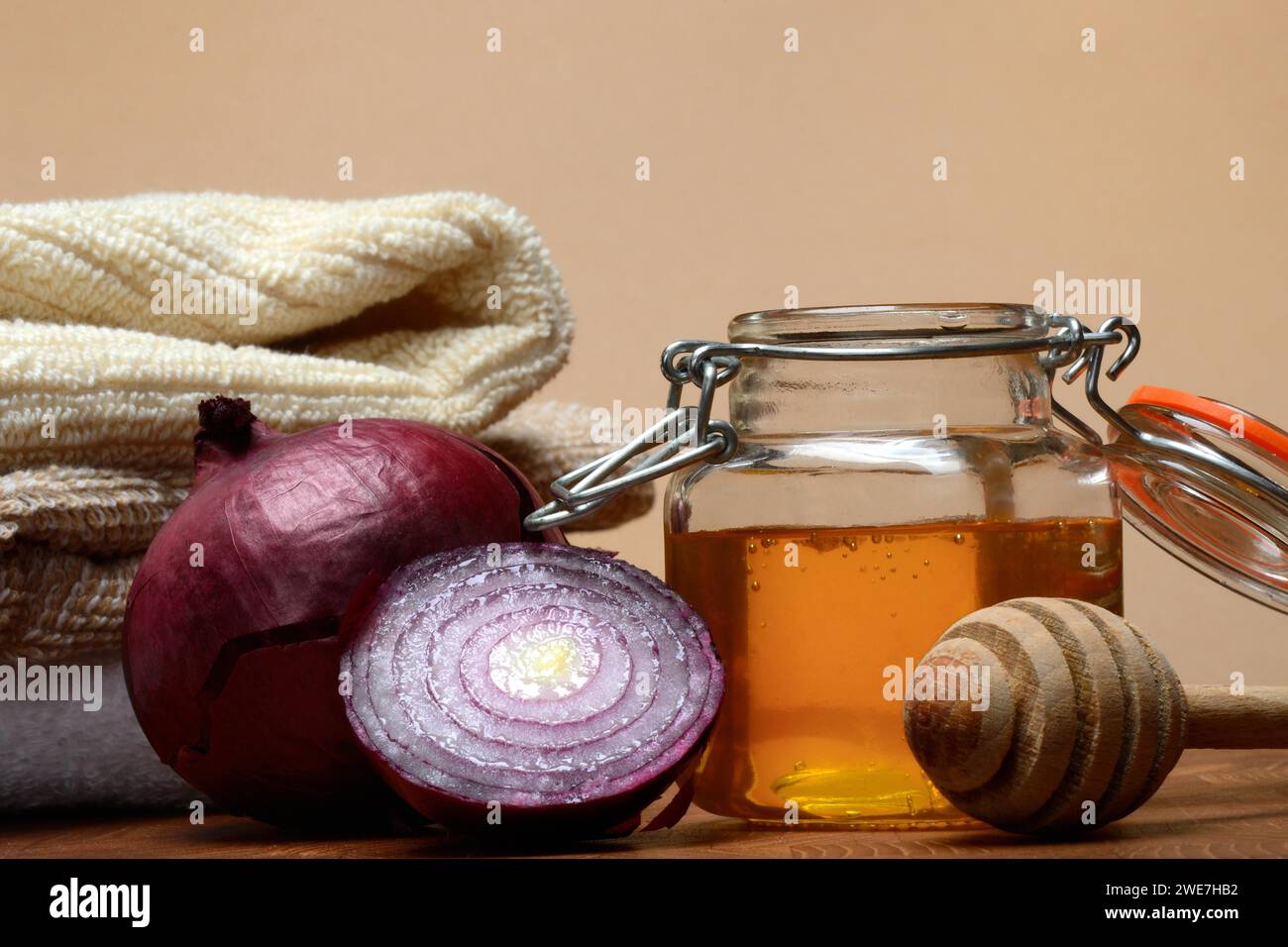 Honey in a jar and red onion, ingredients for cough syrup Stock Photo