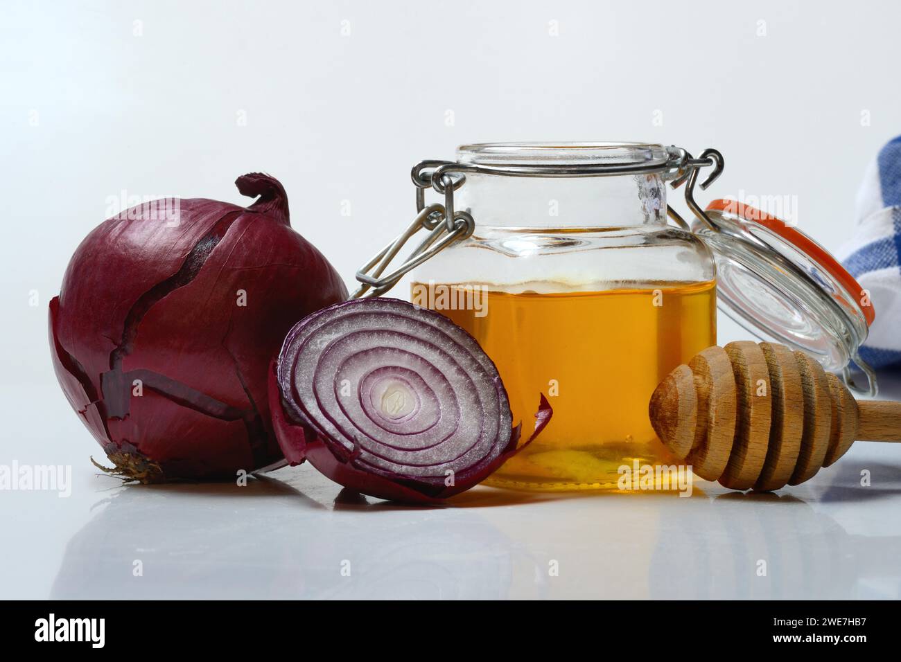 Honey in a jar and red onion, ingredients for cough syrup Stock Photo