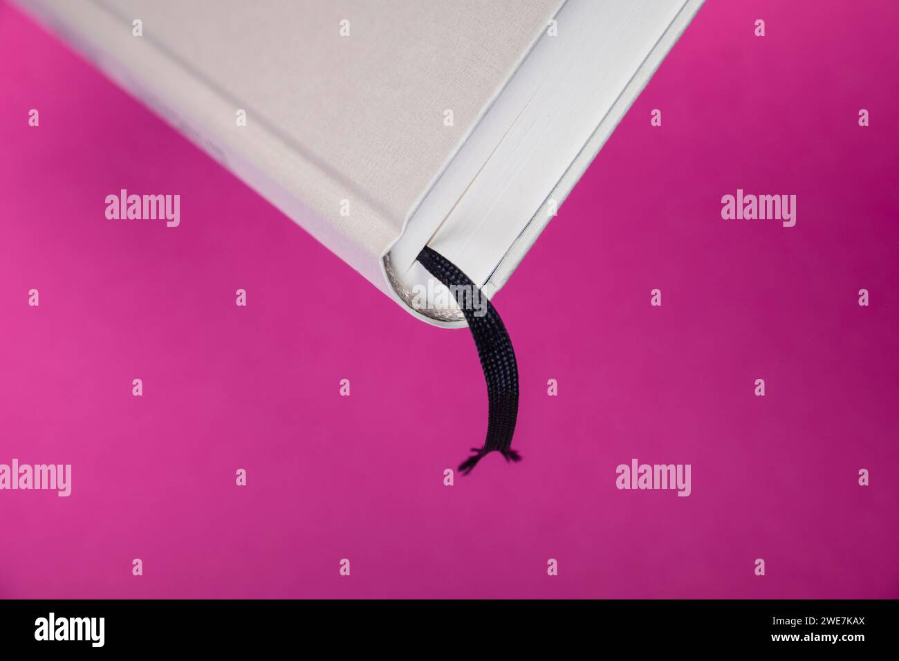 Liquor ribbon in a book against a monochrome background Stock Photo