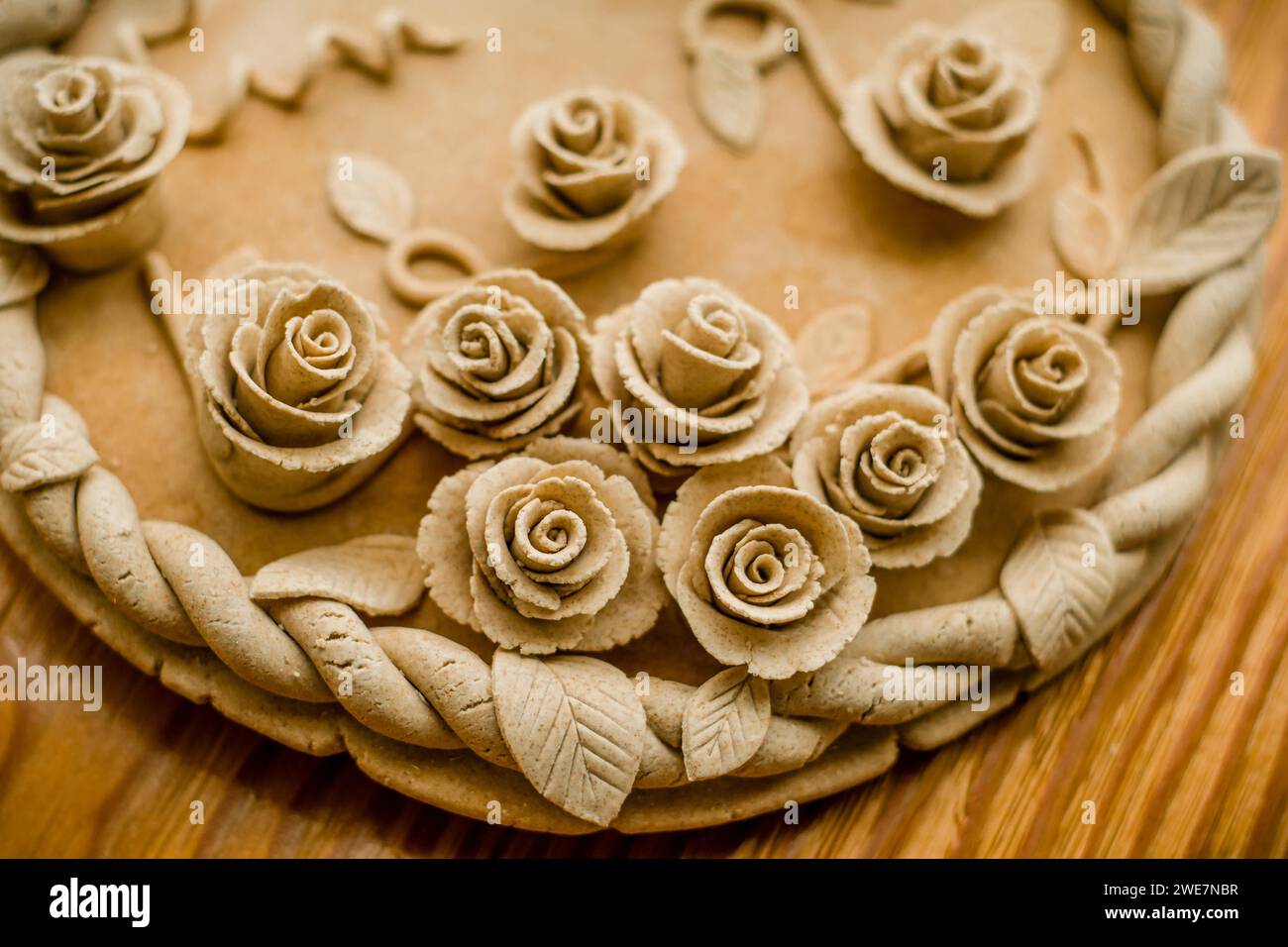 Image of a pastel beige dough sculpture with rose patterns, Teig ...