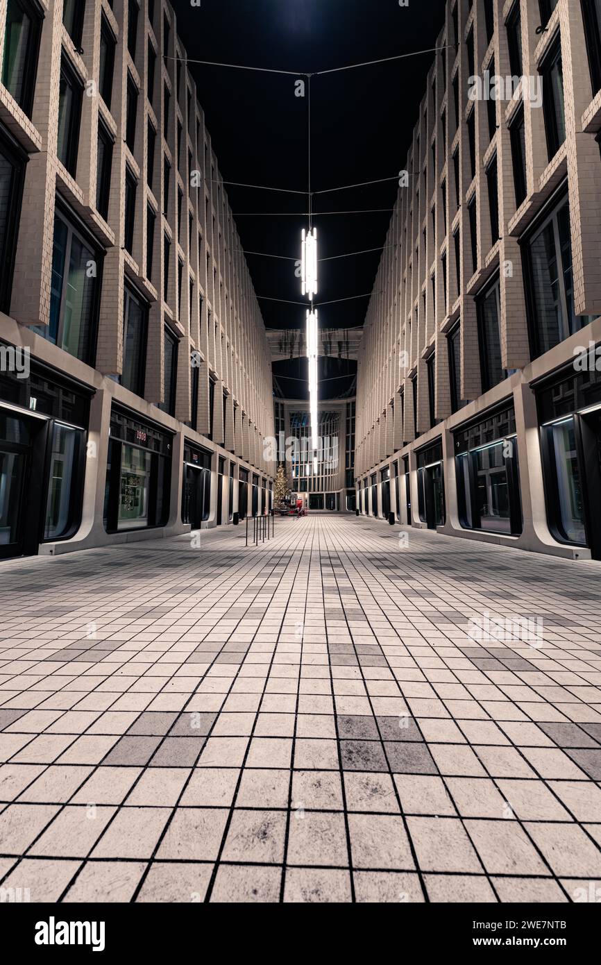 Empty urban street at night with modern illuminated buildings and ...