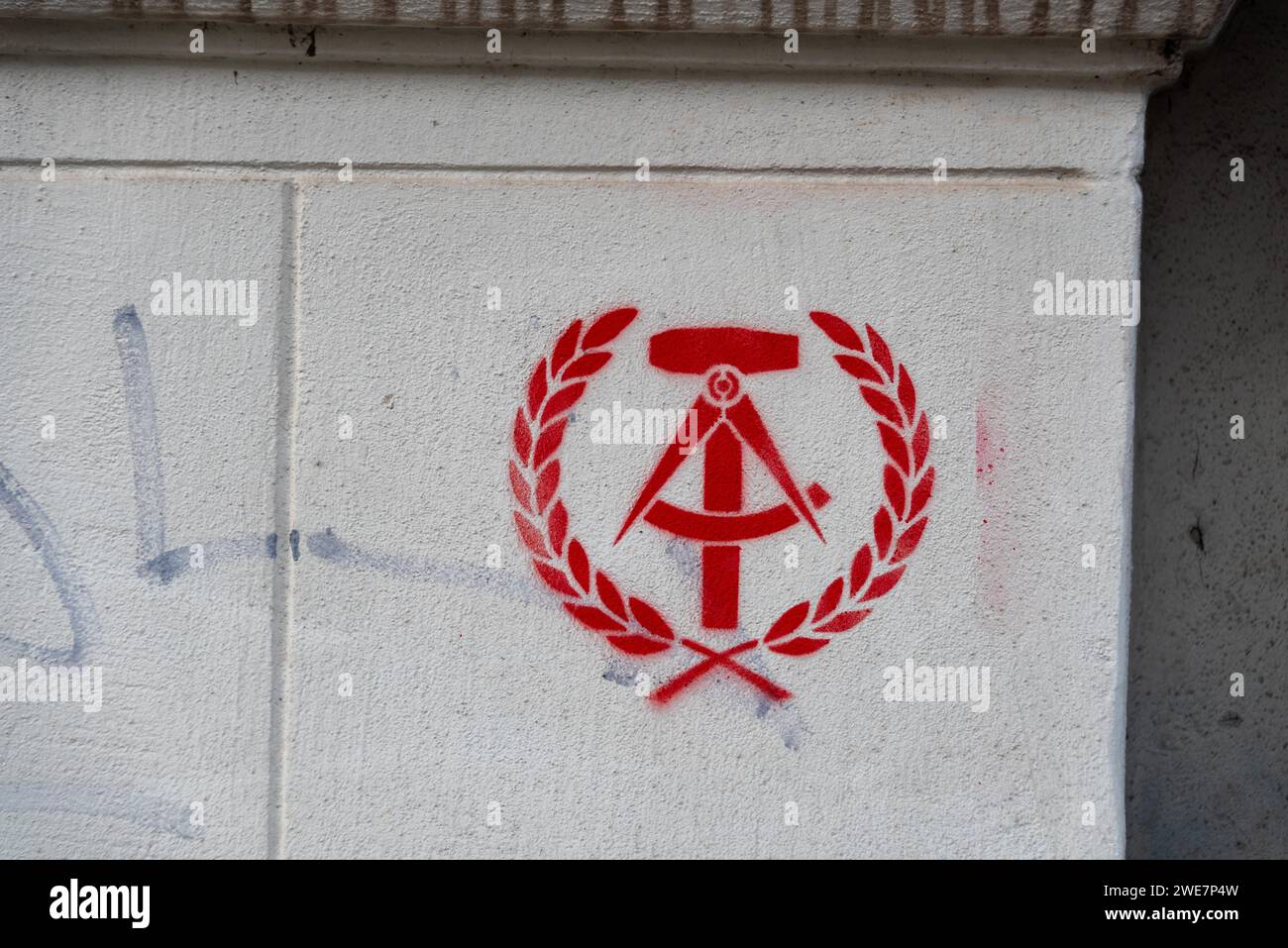 State coat of arms of the GDR as graffiti, hammer, compass, spike wreath, Germany Stock Photo