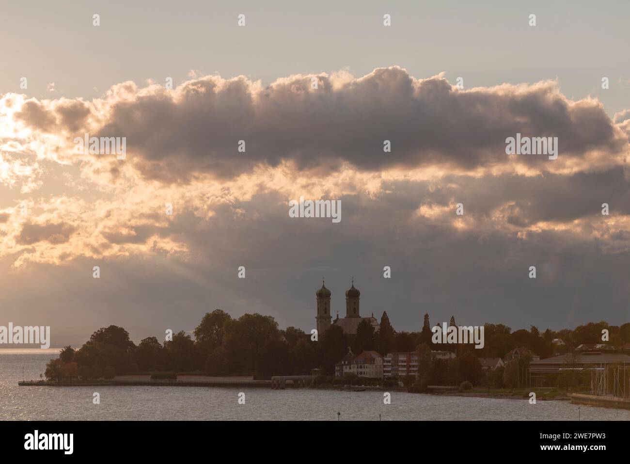 Baroque castle church, double tower, onion dome, evening light, sunbeams, Friedrichshafen on Lake Constance Baden-Wuerttemberg, Germany Stock Photo