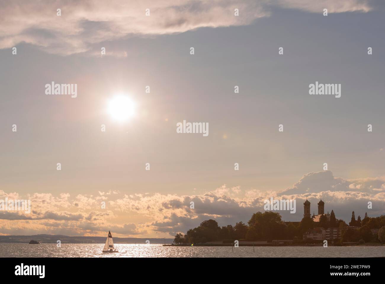 Baroque castle church, double tower, onion dome, evening light, sailing boat, Friedrichshafen on Lake Constance Baden-Wuerttemberg, Germany Stock Photo