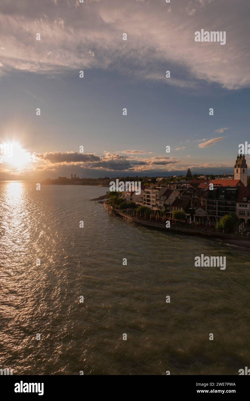 Cityscape, waterfront promenade, church tower, evening light, water reflection, Friedrichshafen on Lake Constance Baden-Wuerttemberg, Germany Stock Photo