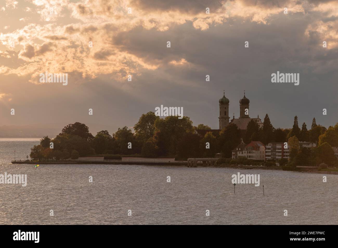 Baroque castle church, double tower, onion dome, evening light, sunbeams, Friedrichshafen on Lake Constance Baden-Wuerttemberg, Germany Stock Photo