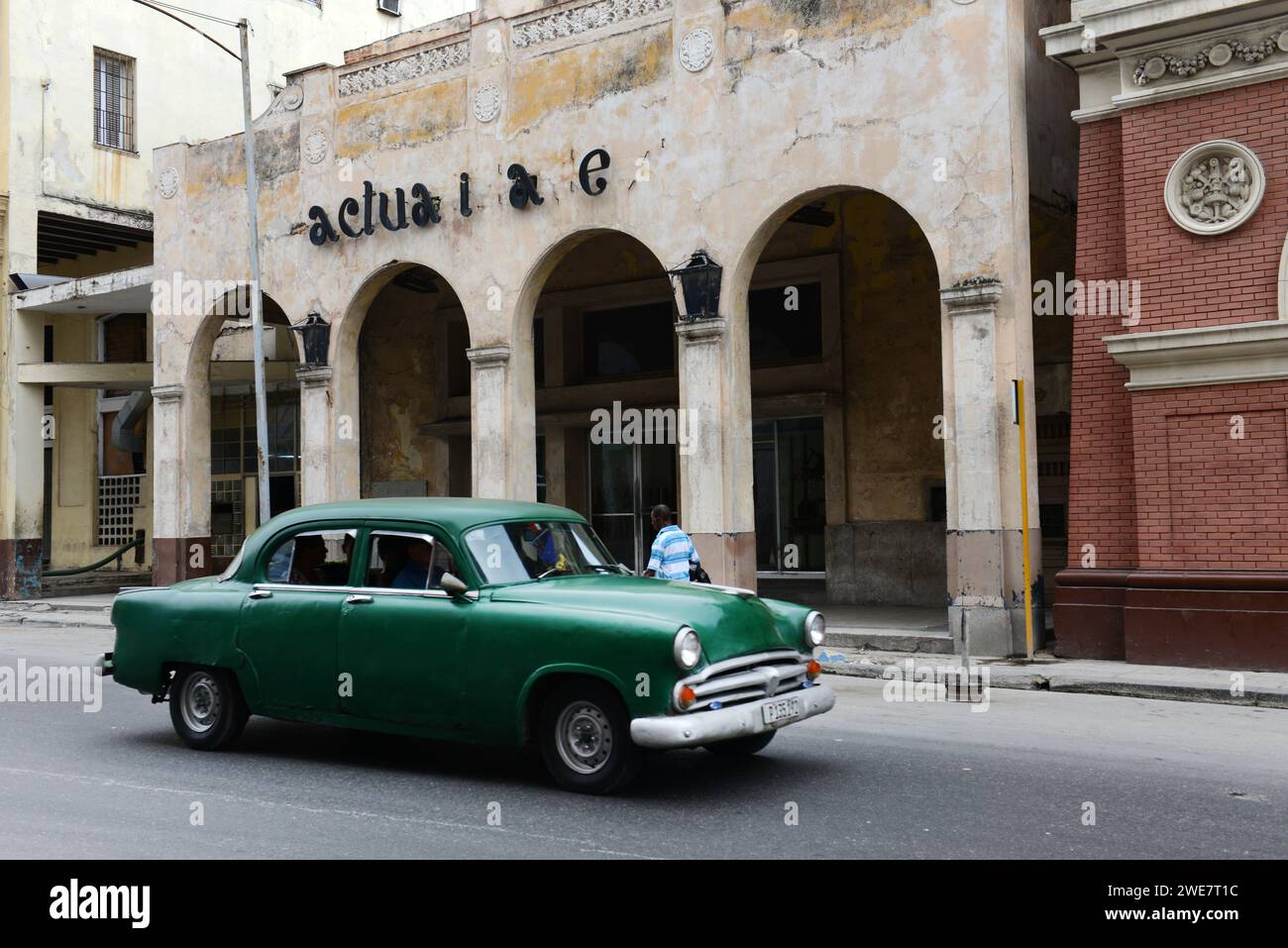 A 1950's American car next to the actualiddades cinema in Havana, Cuba. Stock Photo