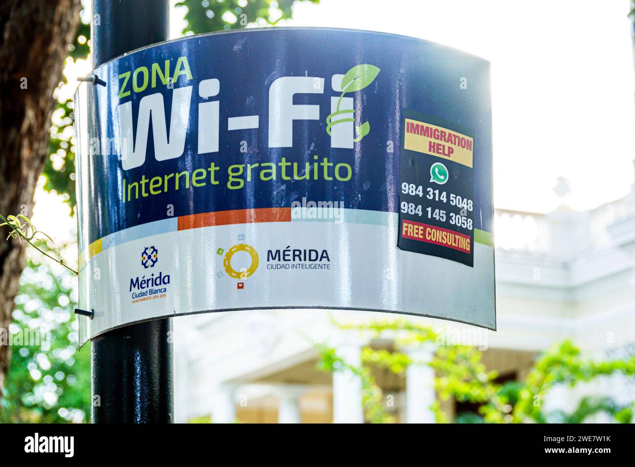 Merida Mexico,Zona Paseo Montejo Centro,sign free wi-fi Internet zone,ad immigration help free consulting,two 2 languages multiple,bilingual multiling Stock Photo