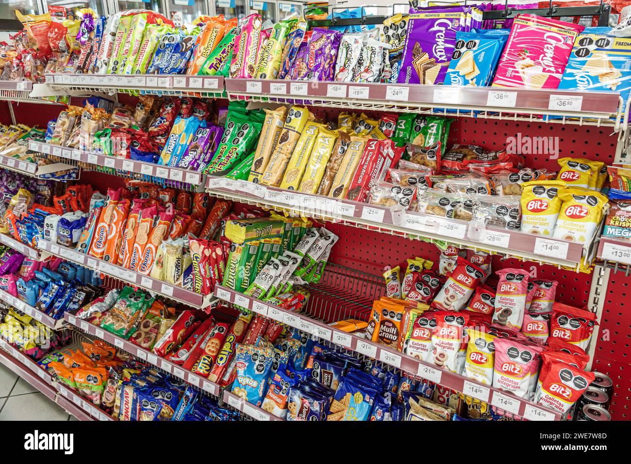 Merida Mexico,Zona Paseo Montejo Centro,Oxxo convenience food store business bodega grocery,sale display shelves,junk food candies cookies,inside inte Stock Photo