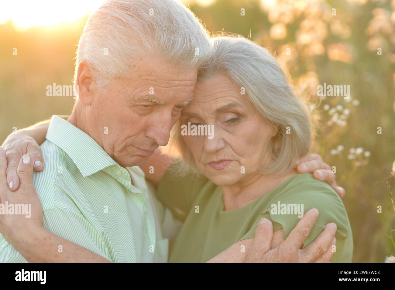 Portrait of sad elderly couple standing outdoors Stock Photo