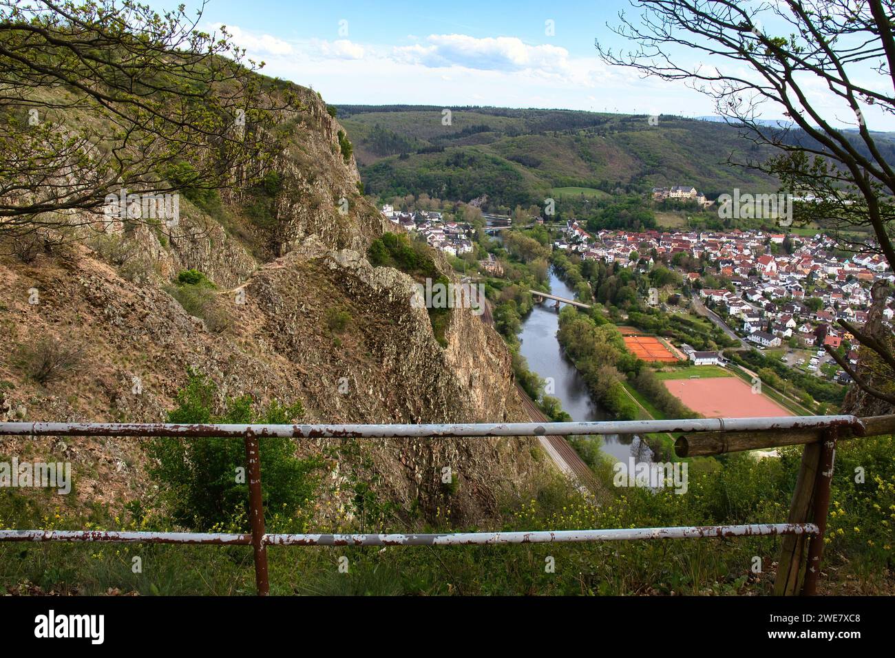 Bad Munster, Germany - May 9, 2021: Walking path with a rail at Rotenfels overlooking the town of Bad Munster and the Nahe River in Germany. Stock Photo