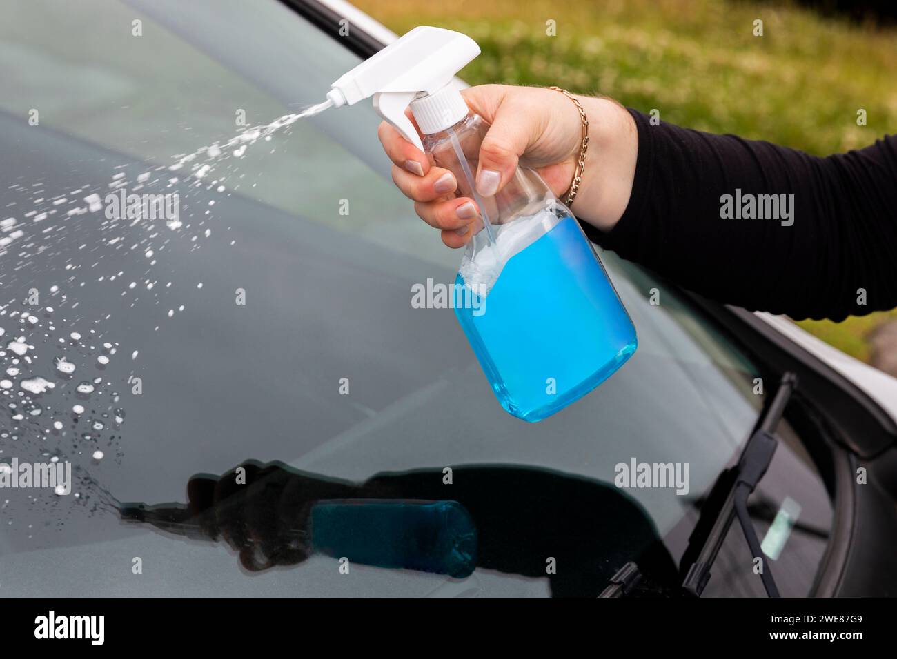 Spraying a blue cleaning solution hires stock photography and images