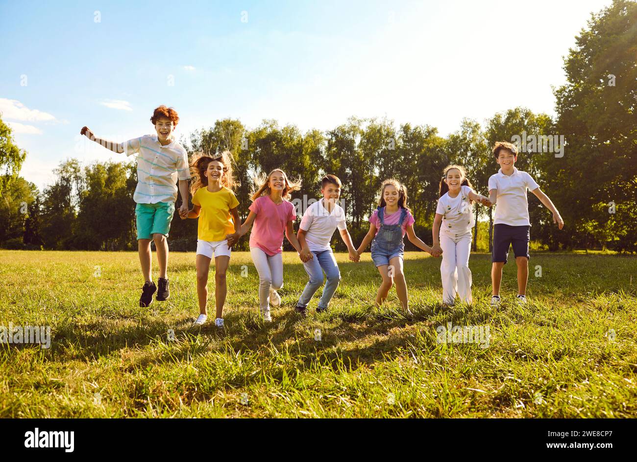 Group of a happy smiling kids friends having fun and jumping in the ...