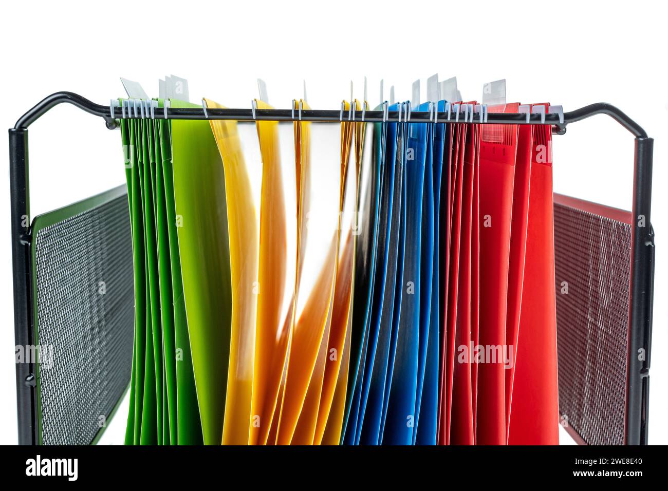 Closeup view of the colorful hanging file folder on the file organizer isolated over a white background Stock Photo