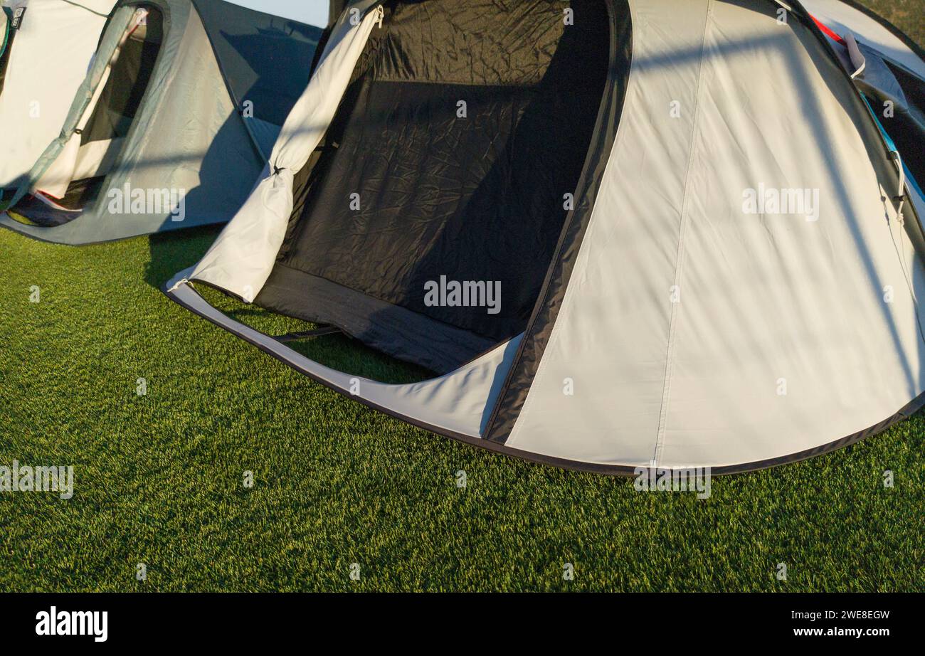 Iglu tents installed on artificial grass. Sunny natural light Stock Photo