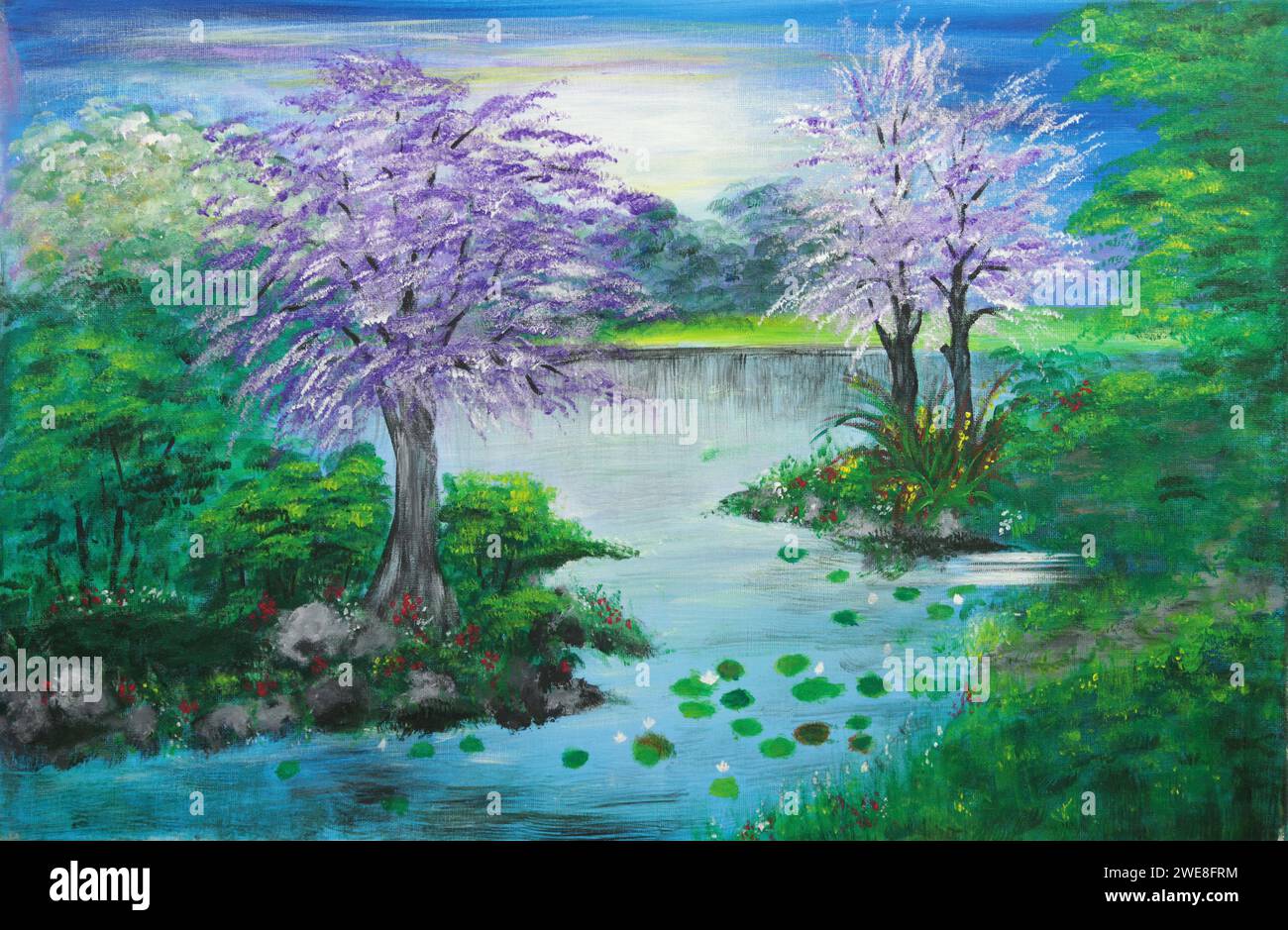 Purple flowering trees along the river in spring time Stock Photo