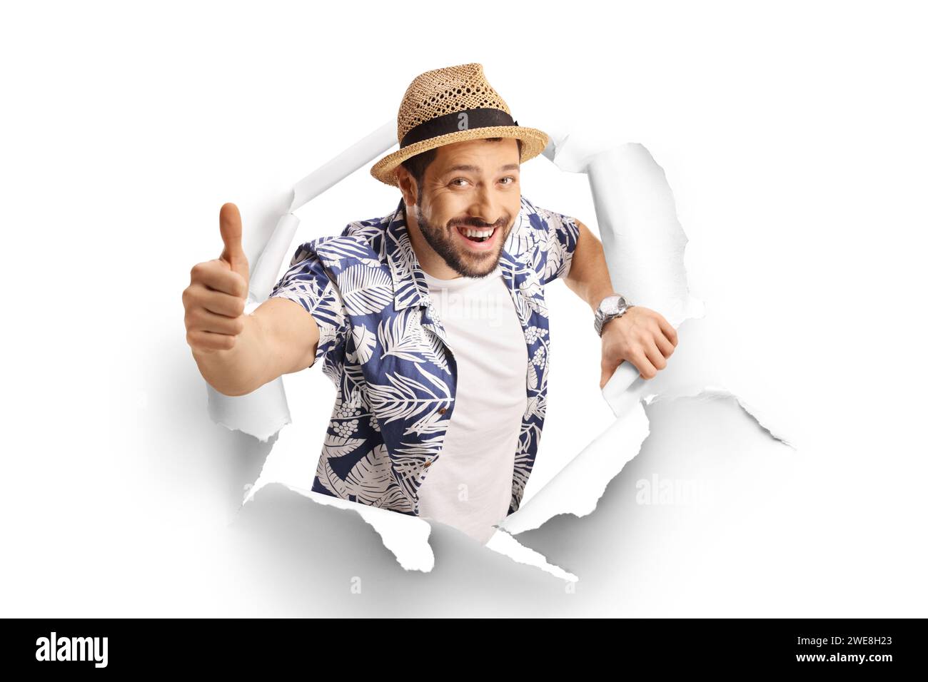 Man showing thumbs up through a paper hole isolated on white background ...