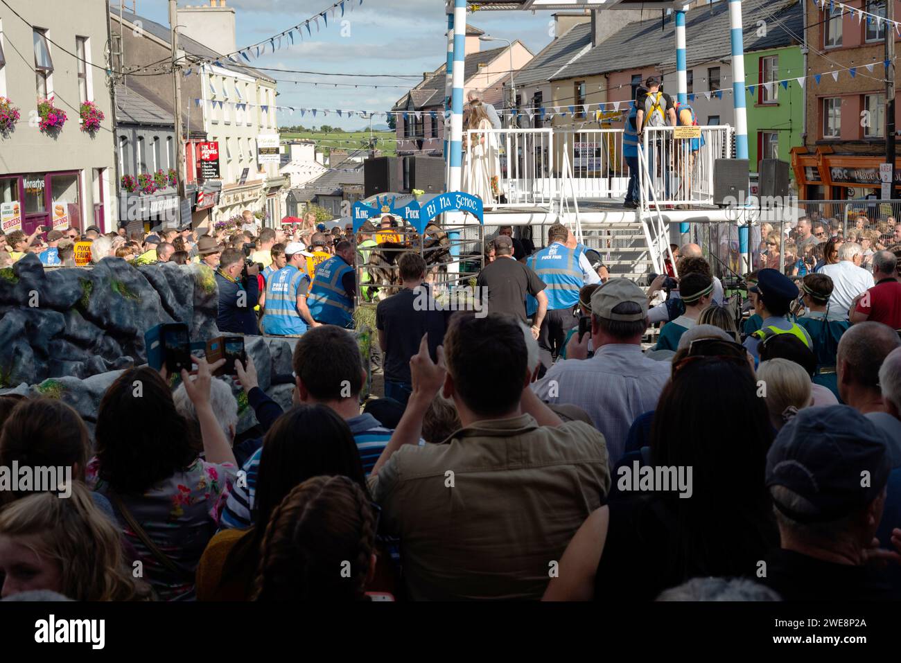 Visitors attending the Puck Fair ceremony of raising the cage with King Puck the goat onto a dedicated platform in Killorglin, County Kerry, Ireland Stock Photo