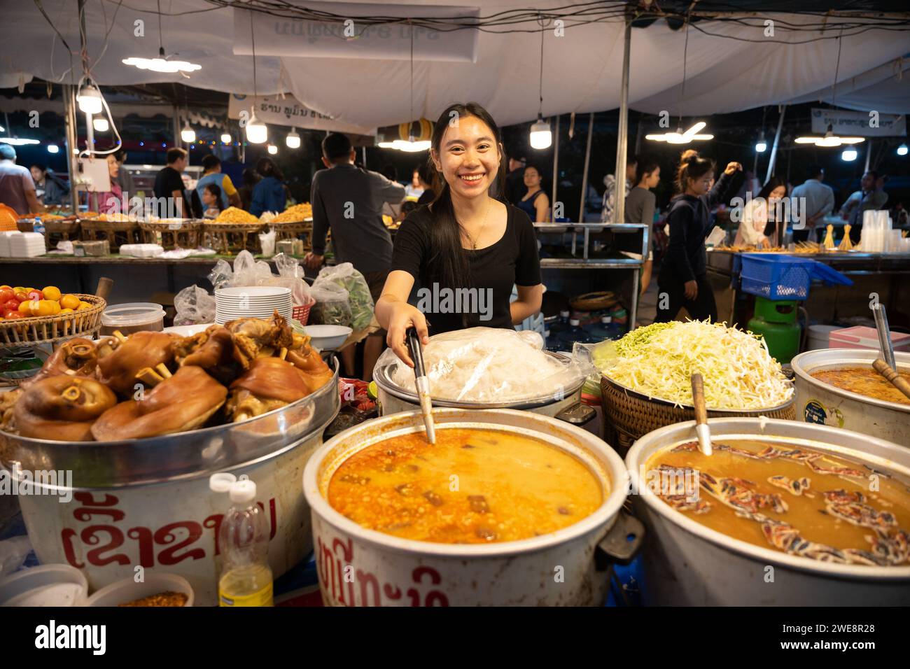 Vientiane. 23rd Jan, 2024. A vendor sells food during Lao Food Festival