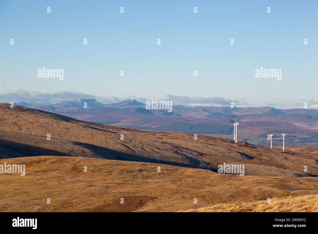 Looking North from the summit of Ben Cleuch towards a windfarm on Burnfoot Hill in the Ochil Hills Stock Photo