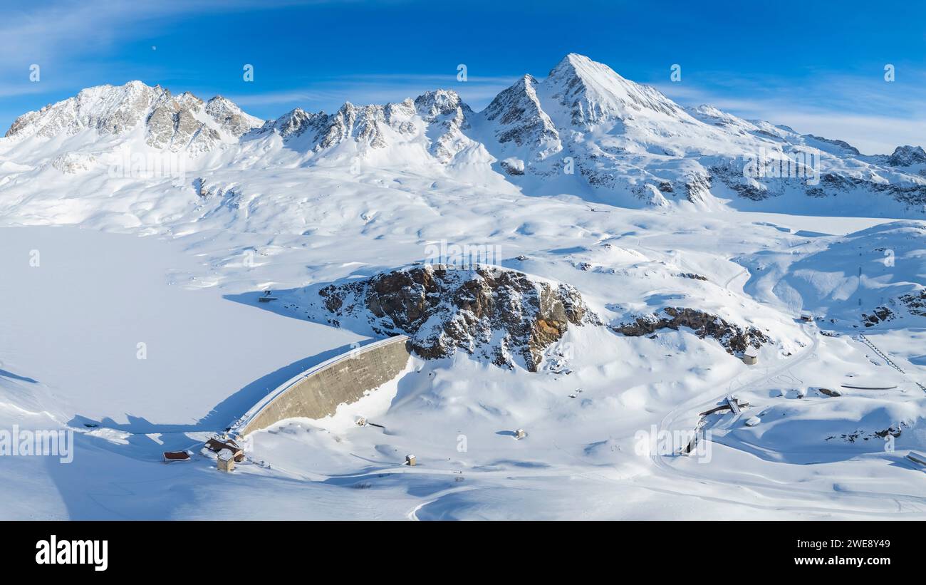 The dam of Toggia Lake, Kastel Lake and Kastelhorn in high Formazza Valley in winter. Riale, Formazza, Valle Formazza, VCO, Piedmont, Italy. Stock Photo