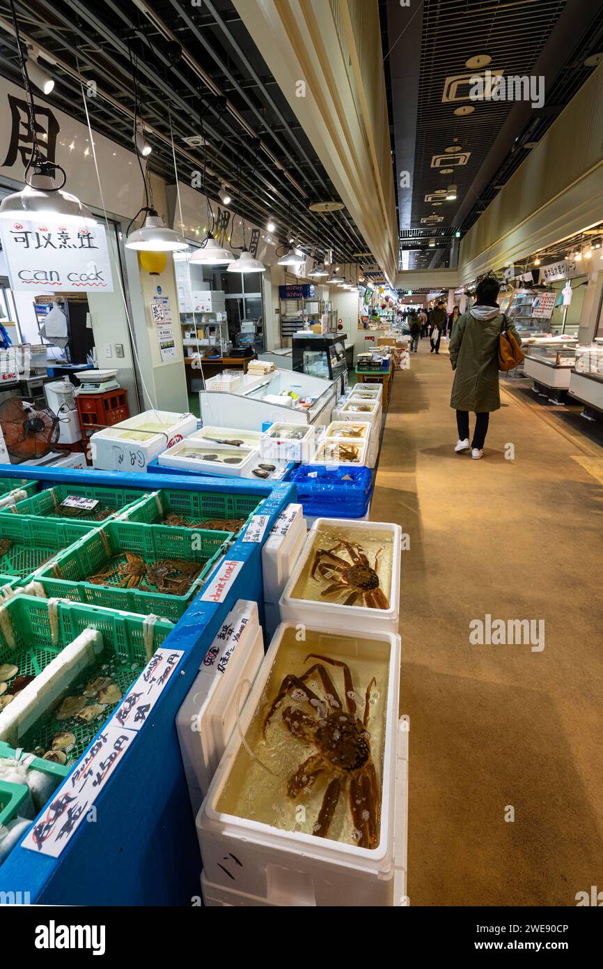 Tokyo, Japan. January 2024. People among stalls selling fresh fish at