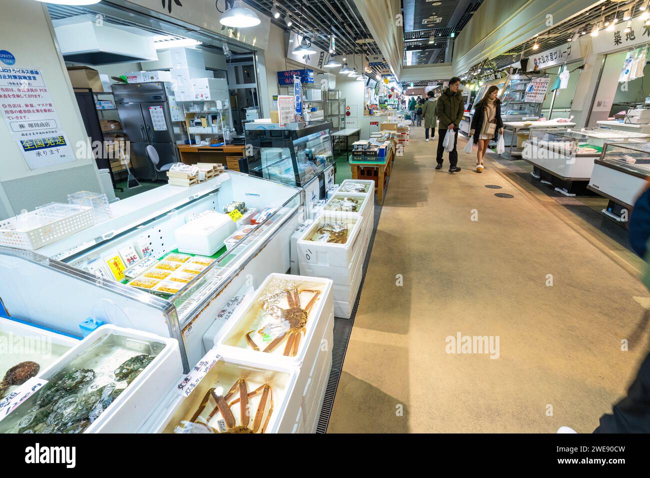 Tokyo, Japan. January 2024. People among stalls selling fresh fish at