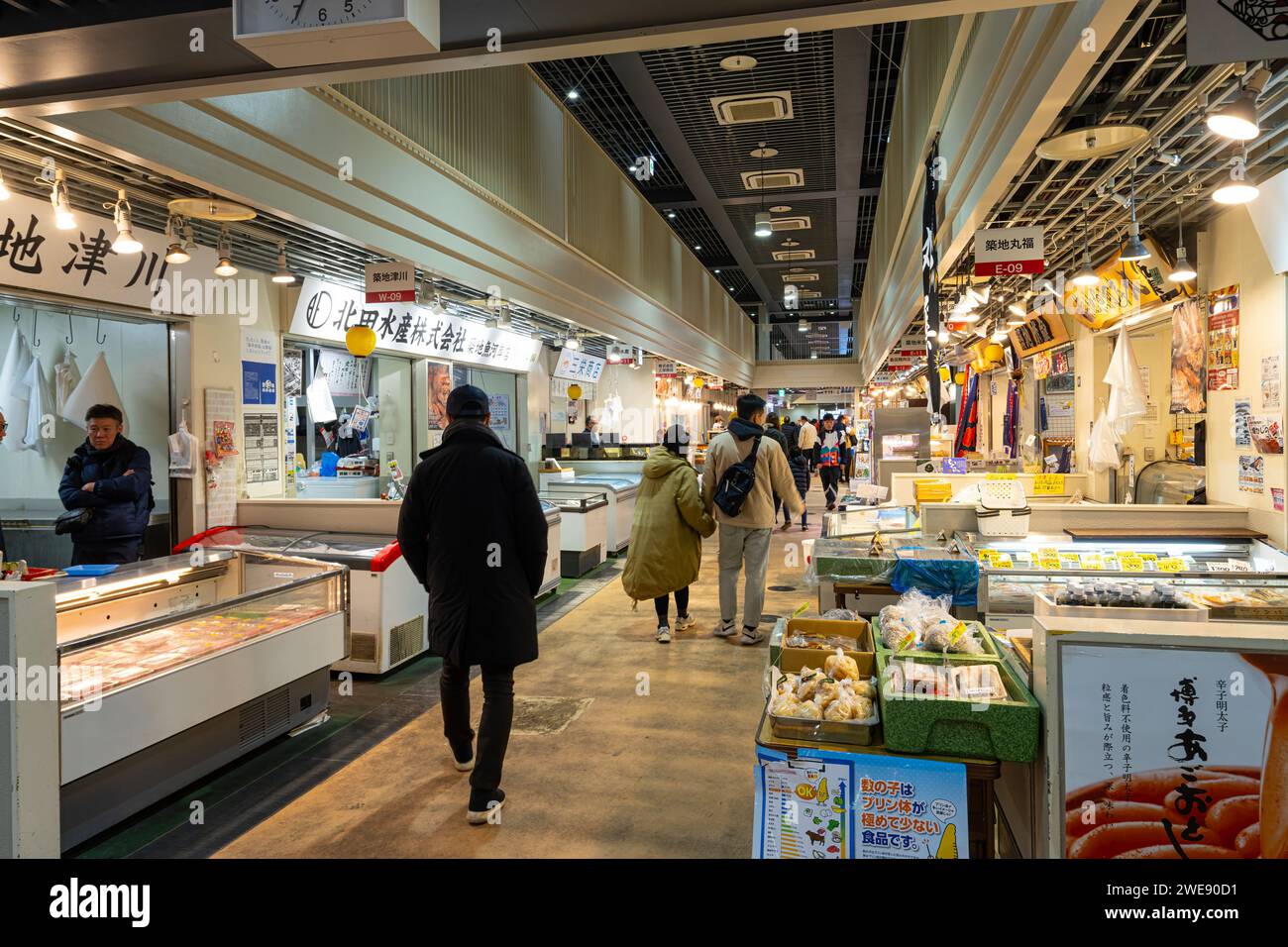 Tokyo, Japan. January 2024. People among stalls selling fresh fish at the Tsukiji Outer Market in the city centre Stock Photo