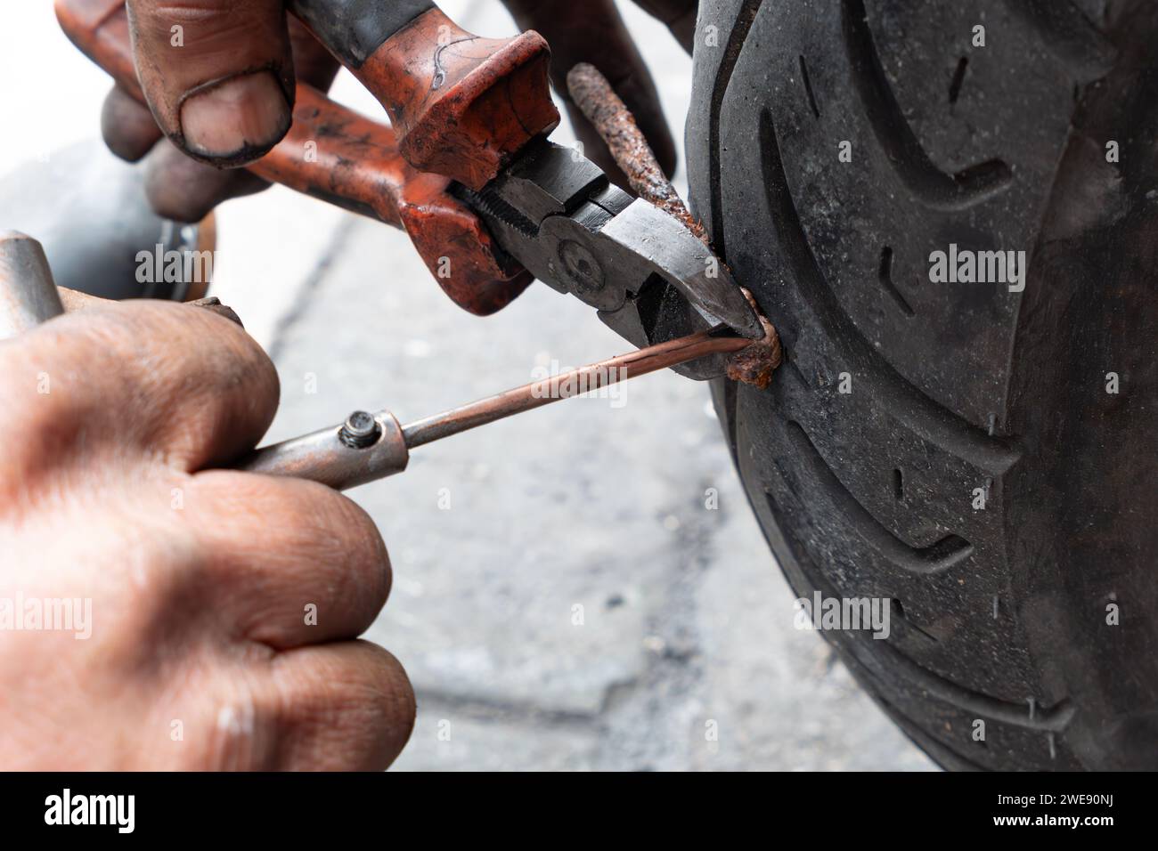 man installing a patch and fixing a tire Stock Photo