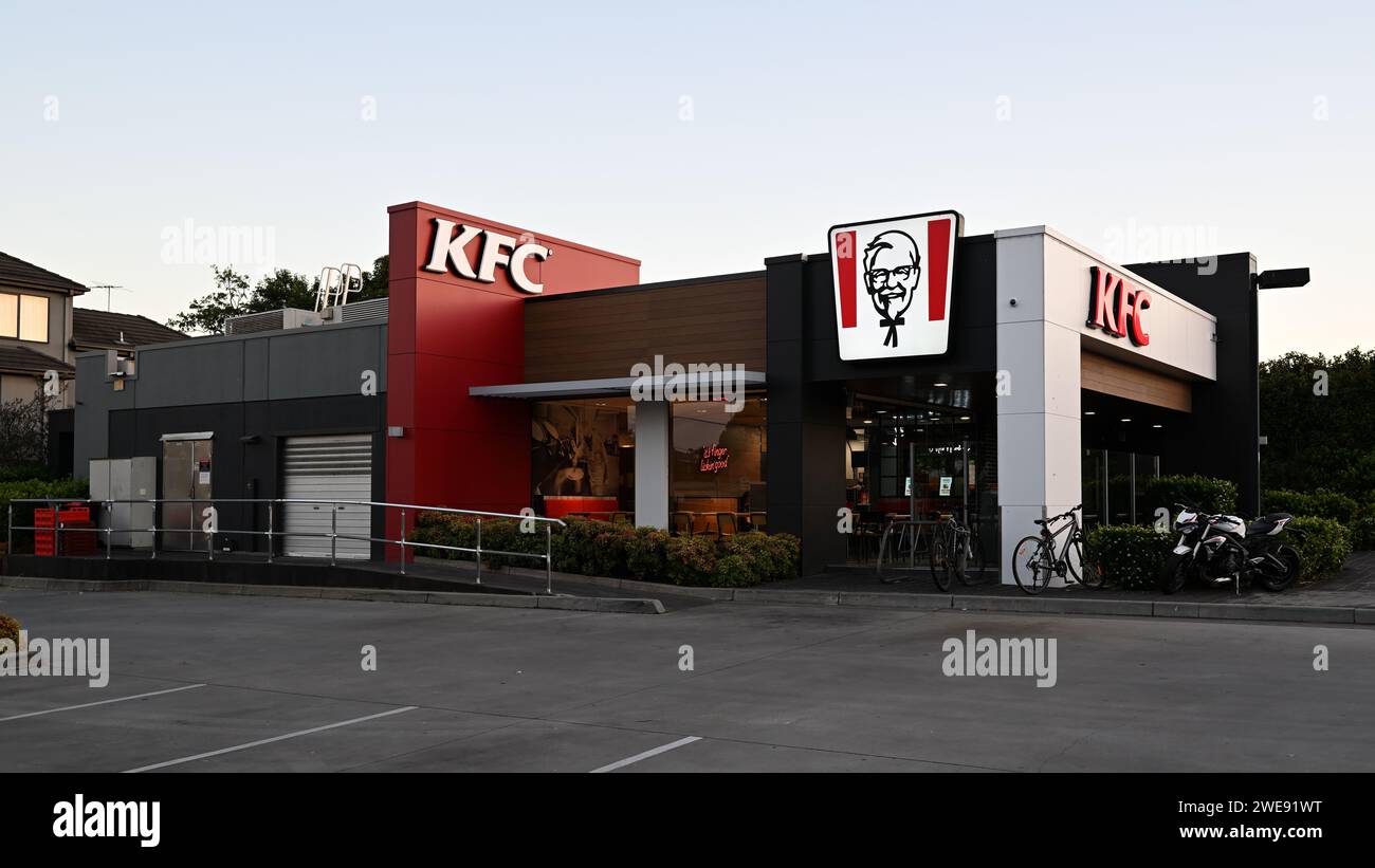 Exterior of KFC fast food restaurant in suburban Melbourne, featuring illuminated Colonel