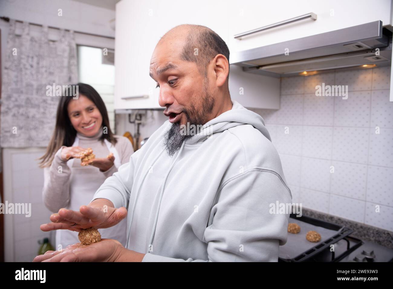 Man having fun with cookie dough prepared at home. Stock Photo