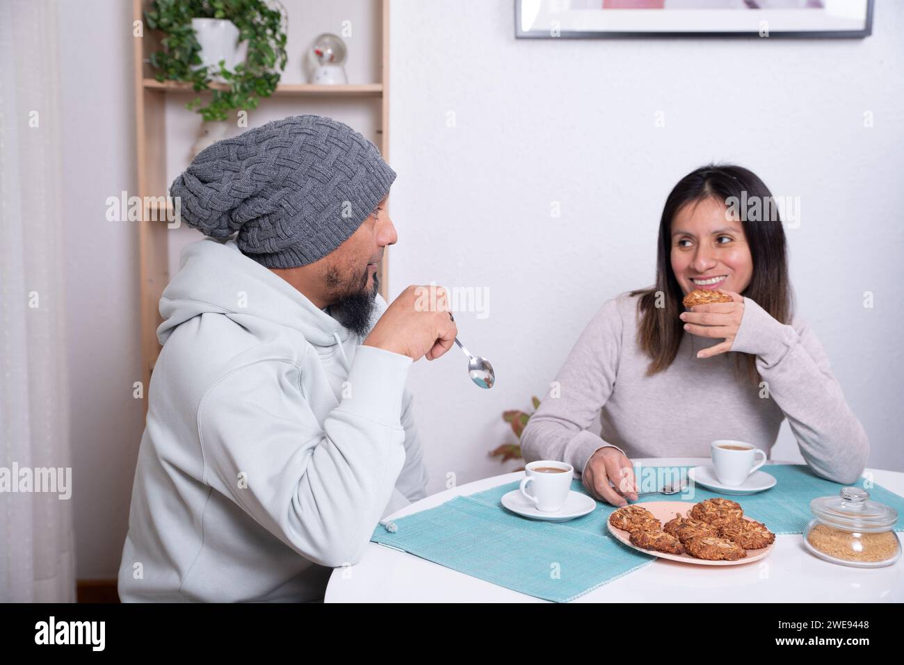 Couple enjoy cookies prepared by themselves at home. Stock Photo