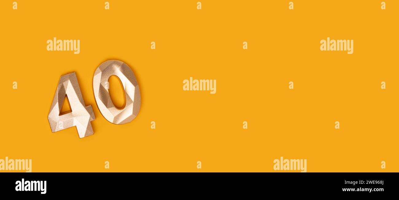 Banner with golden number 40 on a yellow background. Place for text. Stock Photo