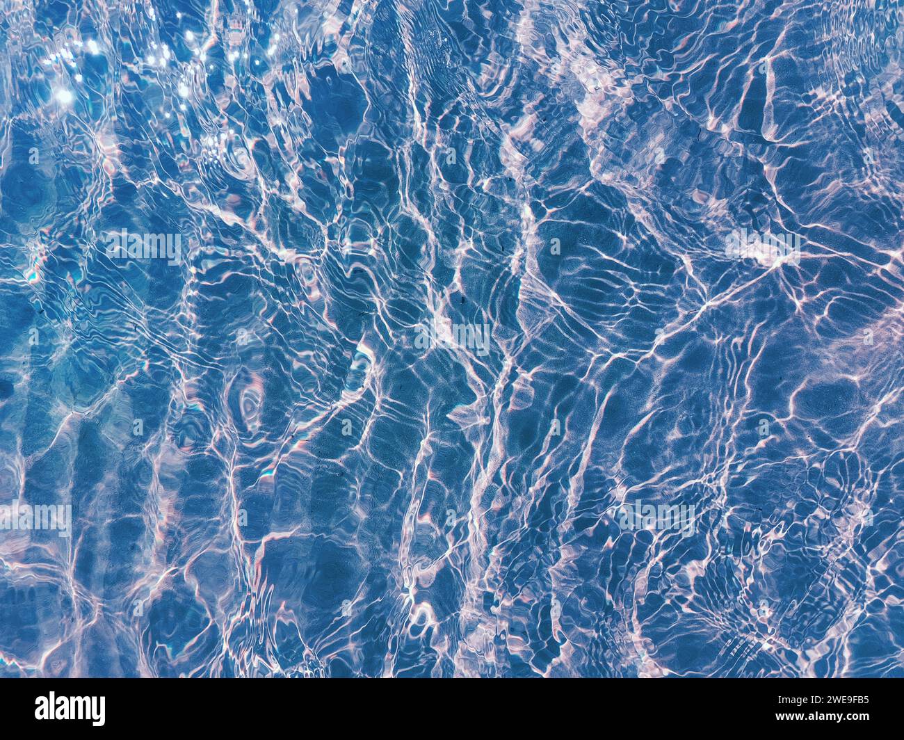 Splashes Water Ripple Water ripple over sandy beach. Transparent blue colored clear water ...
